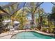 Tranquil screened-in pool area with view of canal, perfect for relaxation and entertaining at 18446 Burkholder Cir, Port Charlotte, FL 33948