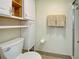 Clean bathroom features a toilet, a walk-in shower, and white storage cabinets at 19505 Quesada Ave # Ee202, Port Charlotte, FL 33948