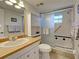 Bathroom with glass enclosed shower, updated vanity, and decorative accents at 19505 Quesada Ave # Ee202, Port Charlotte, FL 33948