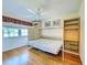 Bedroom featuring a built-in Murphy bed, storage and hardwood flooring at 19505 Quesada Ave # Ee202, Port Charlotte, FL 33948