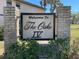 Welcome to The Oaks IV community sign, surrounded by greenery and stone pillars at 19505 Quesada Ave # Ee202, Port Charlotte, FL 33948