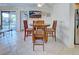 Bright dining area features tile floors, a wood table with four chairs, and a wall-mounted TV at 19505 Quesada Ave # Ee202, Port Charlotte, FL 33948