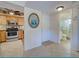 Inviting entryway leading to an open kitchen and adjacent bathroom at 19505 Quesada Ave # Ee202, Port Charlotte, FL 33948