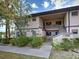 Charming condo exterior with covered entry and lush, mature landscaping at 19505 Quesada Ave # Ee202, Port Charlotte, FL 33948