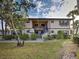 Inviting exterior view of condo complex with mature landscaping and pedestrian walkway at 19505 Quesada Ave # Ee202, Port Charlotte, FL 33948