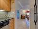 The kitchen pass-through provides a glimpse into the comfortable living area at 19505 Quesada Ave # Ee202, Port Charlotte, FL 33948