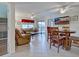 Bright living room and dining area with tiled floors and a sliding glass door at 19505 Quesada Ave # Ee202, Port Charlotte, FL 33948