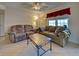 Relaxing living room space with comfortable seating, ceiling fan and natural light at 19505 Quesada Ave # Ee202, Port Charlotte, FL 33948