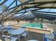 Spacious covered pool area with plenty of seating and clear roofing panels at 19505 Quesada Ave # Ee202, Port Charlotte, FL 33948