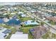Expansive aerial view highlights waterfront homes with boat docks and pools, interwoven by canals and lush greenery at 1960 W Marion Ave, Punta Gorda, FL 33950