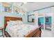 Bedroom featuring a bed and a sliding glass door with access to an outdoor space at 1960 W Marion Ave, Punta Gorda, FL 33950