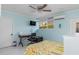 Bedroom with desk area, light blue walls, ceiling fan and TV at 1960 W Marion Ave, Punta Gorda, FL 33950
