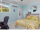 Bedroom with desk area, light blue walls, ceiling fan, and exterior access door at 1960 W Marion Ave, Punta Gorda, FL 33950