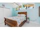 Bright bedroom featuring a wood frame bed, white tile floors, and modern windows at 1960 W Marion Ave, Punta Gorda, FL 33950