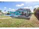 Beautifully landscaped exterior with a pool, patio, and lush greenery, offering a private retreat at 1960 W Marion Ave, Punta Gorda, FL 33950