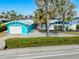 Charming curb appeal of a modern home showcasing a bright blue exterior, neat landscaping, and a welcoming driveway at 1960 W Marion Ave, Punta Gorda, FL 33950