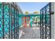 Inviting entrance featuring a decorative gate, brick pavers, and vibrant coral doors at 1960 W Marion Ave, Punta Gorda, FL 33950