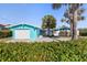 Charming home with a vibrant blue exterior, neat landscaping, and welcoming curb appeal at 1960 W Marion Ave, Punta Gorda, FL 33950