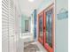 Bright hallway with a coral door, white trim, and stylish decorations at 1960 W Marion Ave, Punta Gorda, FL 33950