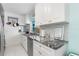 Modern kitchen boasts sleek stainless steel appliances and striking granite countertops at 1960 W Marion Ave, Punta Gorda, FL 33950