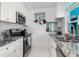 Modern kitchen boasts sleek stainless steel appliances, white brick wall and granite countertops at 1960 W Marion Ave, Punta Gorda, FL 33950