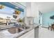 Modern kitchen boasts sleek stainless steel appliances and beautiful countertops and a view at 1960 W Marion Ave, Punta Gorda, FL 33950