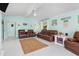 Cozy living room with comfortable leather furniture, ample light, and stylish coastal decorations at 1960 W Marion Ave, Punta Gorda, FL 33950