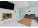 Relaxing living room showcasing a fireplace, a wall-mounted TV, and coastal-themed accents at 1960 W Marion Ave, Punta Gorda, FL 33950