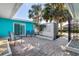 This cozy patio features blue outdoor seating and a decorative lattice brick wall, perfect for relaxing outside at 1960 W Marion Ave, Punta Gorda, FL 33950