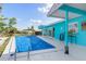 Inviting pool area with bar seating, lush greenery, and clear water for outdoor enjoyment at 1960 W Marion Ave, Punta Gorda, FL 33950