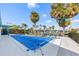 Outdoor pool area with canal access, palm trees, and blue skies at 1960 W Marion Ave, Punta Gorda, FL 33950