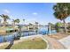 Serene waterfront view featuring a private dock, palm trees, and tranquil waters at 1960 W Marion Ave, Punta Gorda, FL 33950