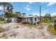 House with backyard showcasing gravel landscaping and dated exterior at 212 Gulf Ave, Nokomis, FL 34275