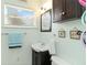 Cozy bathroom featuring a modern vanity, framed nautical art, and bright natural lighting at 212 Gulf Ave, Nokomis, FL 34275