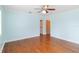 Bright bedroom featuring hardwood floors, ceiling fan, and easy access to closet at 212 Gulf Ave, Nokomis, FL 34275