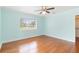 Airy bedroom with neutral walls, hardwood floors, and large windows allowing plenty of natural light at 212 Gulf Ave, Nokomis, FL 34275