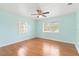 Bedroom with hardwood floors, white ceiling, and large window offering ample natural light at 212 Gulf Ave, Nokomis, FL 34275