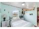 Charming bedroom featuring natural lighting, white walls, and calming nautical decor at 212 Gulf Ave, Nokomis, FL 34275