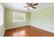 Well-lit bedroom features hardwood floors and bright natural lighting at 212 Gulf Ave, Nokomis, FL 34275