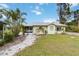 Charming home featuring a well-manicured lawn and vibrant landscaping at 212 Gulf Ave, Nokomis, FL 34275