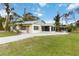 Inviting home with a well-maintained lawn and an expansive driveway at 212 Gulf Ave, Nokomis, FL 34275