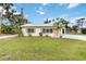 Charming single-story home featuring a well-maintained lawn and inviting pink front door at 212 Gulf Ave, Nokomis, FL 34275