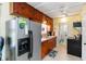 Functional kitchen with stainless steel appliances, wood cabinetry, and a tile floor at 212 Gulf Ave, Nokomis, FL 34275