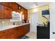 Functional kitchen with stainless steel sink, wood cabinetry, and black stove at 212 Gulf Ave, Nokomis, FL 34275