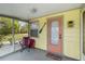 Covered front porch with seating creates a cozy and inviting entrance to the home at 212 Gulf Ave, Nokomis, FL 34275