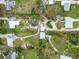 An aerial shot shows neighborhood homes and lawns intermixed with overgrown land, highlighting a mix of residential spaces at 217 Palm E Ave, Nokomis, FL 34275