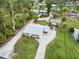 Aerial view of the home showcasing the property's layout with a screened porch and the surrounding landscaped grounds at 217 Palm E Ave, Nokomis, FL 34275