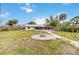Lush backyard featuring a charming fire pit area and a brick paver walkway, creating an inviting outdoor space at 217 Palm E Ave, Nokomis, FL 34275