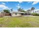 Well-maintained backyard showcasing the home's screened porch and fence line, enhancing privacy and outdoor enjoyment at 217 Palm E Ave, Nokomis, FL 34275