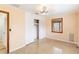 Cozy bedroom with ceiling fan, window, polished terrazzo flooring, and spacious closet at 217 Palm E Ave, Nokomis, FL 34275